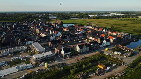 Aerial-of-a-newly-built-town-with-a-hot-air-balloon-in-the-distance