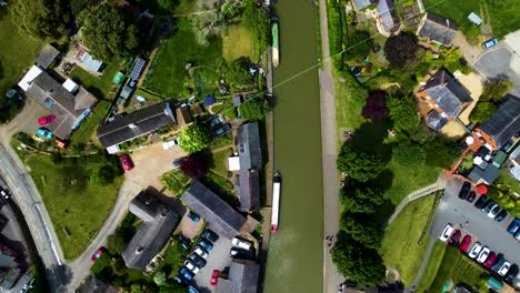 High-aerial-bird's-eye-view-pan-along-peaceful-canal-in-stoke-bruerne
