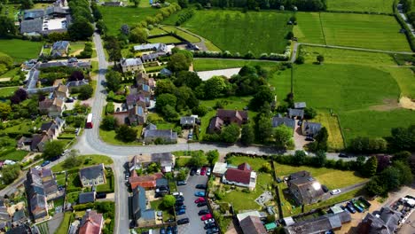 Road-bend-in-Stoke-Bruerne-on-perfect-sunny-day,-aerial-static-establishing