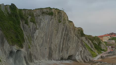 Aerial-reverse-dolly-of-flysch-geologic-cliffside-at-itzurun-zumaia-spain