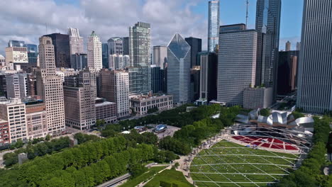 Aerial-view-of-cloud-shadows-moving-over-the-Millennium-Park,-in-sunny-Chicago,-USA---circling,-drone-shot