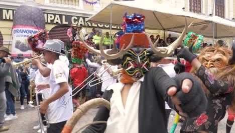 Experience-the-energetic-spirit-as-multiple-Diablada-Pillareña-dancers-perform-energetically-up-close,-captured-in-stunning-4K-resolution-and-60-frames-per-second-during-the-Chagra-Processional-Parade