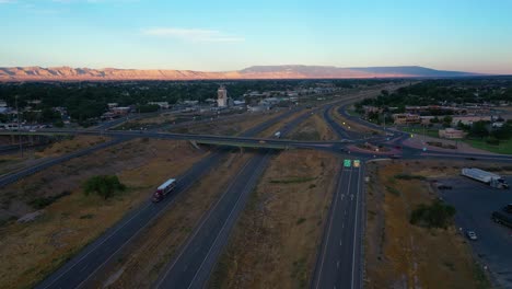 Aerial-view-over-traffic-on-a-Grand-army-of-the-republic-highway,-sunset-in-Fruita,-Colorado,-USA