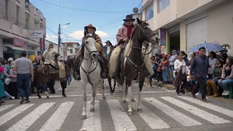 Experience-the-dynamic-interaction-as-two-Chagras-elegantly-approach-the-camera-on-horseback,-with-one-of-them-offering-a-warm-greeting