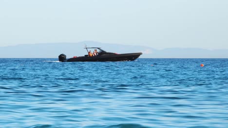 Motorboat-with-black-color-and-cozy-design-sailing-on-sea-horizon,-summer-vacations-in-Mediterranean