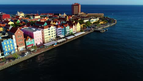 Pullback-rising-showcases-curacao-Willemstad-UNESCO-homes-along-scenic-coastal-road