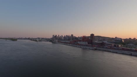 Sunset-to-Night-Aerial-Timelapse-of-Downtown-Montreal-From-Over-the-River-with-Beautiful-Skies-and-City-Lights