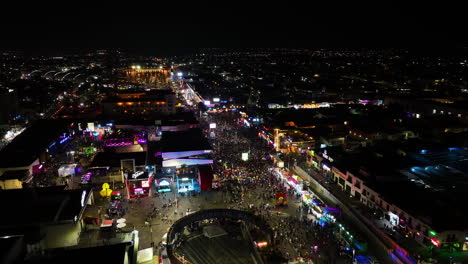 Nightlife-at-the-San-Marcos-fair,-illuminated-Aguascalientes,-Mexico---Aerial-view