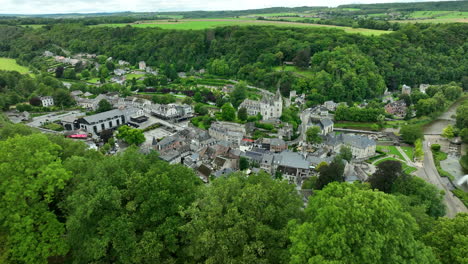 Durbuy-City-Aerial-Reveal-From-Behind-Green-Forested-Hill-Top