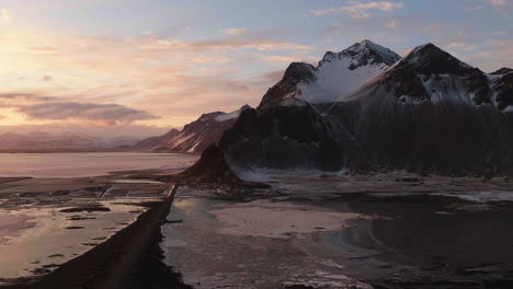 Aerial-pan-shot-overlooking-the-nature-in-Stokksnes,-winter-sunset-in-Iceland