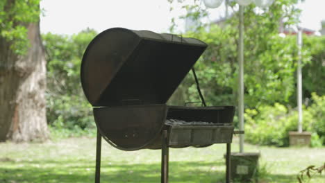 Metal-barbecue-or-BBQ-barrel-for-coal-cooking-in-backyard-or-camping-site