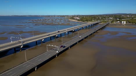 Forward-moving-aerial-view-over-the-Houghton-Highway-Bridge-between-Brighton-and-Redcliffe-Peninsula,-Brisbane-Australia
