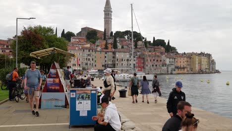 Artist’s-paintings-and-scooter-hire-alongside-the-harbour,-Rovinj,-Croatia