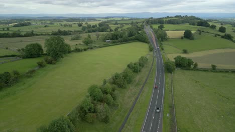 Flying-high-over-main-road-A66-cutting-through-green-summer-landscape