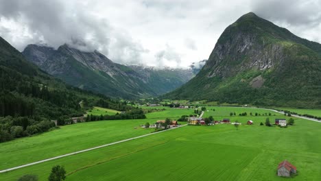 Boyadalen-valley-leading-to-Boyabreen-glacier-in-Fjaerland---Lush-green-valley-with-stunning-mountain-scenery-and-glacier-barely-visible-in-the-background-clouds---60-fps-Norway
