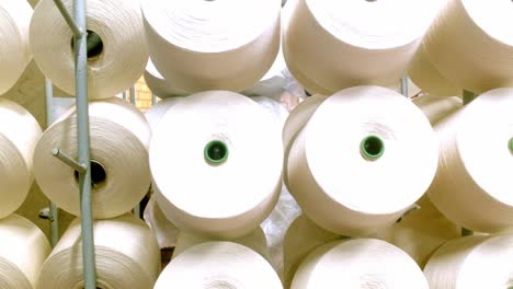 Rolls-of-white-cotton-on-a-rack-at-a-cotton-mill