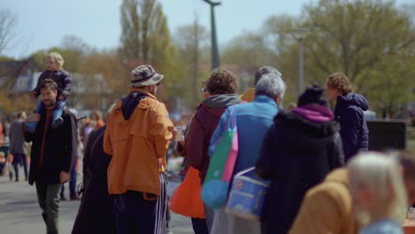 Orange-dressed-people-during-King's-Day-in-Noorderpark-in-Amsterdam