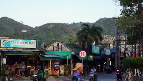 A-busy-street-along-Thawewong-Road-in-Patong,-Phuket,-Thailand
