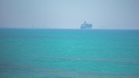 A-Reveal-Shot-Of-A-Ship-On-The-Clear-Ocean-Waters-On-A-Sunny-Weather-Under-The-Blue-Sky