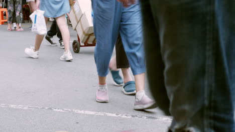 People-walk-the-vibrant-bustle-in-Bangkok's-Chatuchak-Market-with-locals-and-foreigners-shopping-in-Bangkok,-Thailand