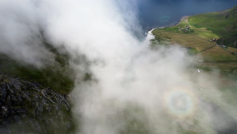 Flying-into-the-clouds-at-Uttakleiv-Beach-in-Lofoten,-Norway