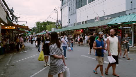People-walk-the-vibrant-bustle-in-Bangkok's-Chatuchak-Market-with-locals-and-foreigners-shopping-in-Bangkok,-Thailand