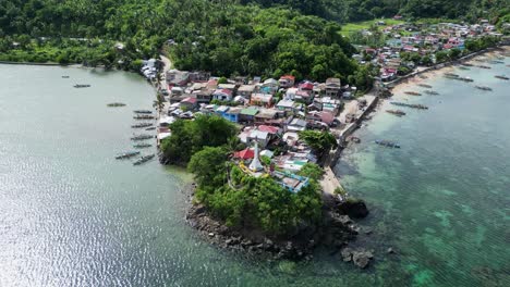 Third-world-house-in-the-Philippines,-aerial-tilt-down-establisher,-fishing-town