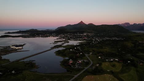 Aerial-shot-of-a-city-during-the-midnight-sun-in-Lofoten,-Norway