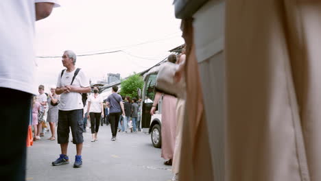 People-walk-the-vibrant-bustle-in-Bangkok's-Chatuchak-Market-with-locals-and-foreigners-shopping-in-Bangkok,-Thailand