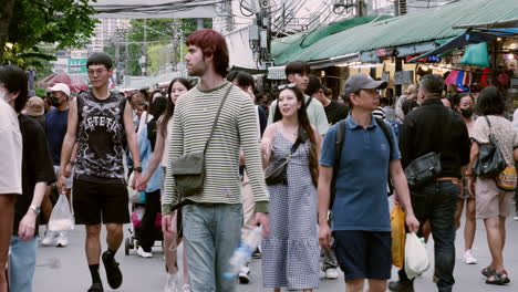 People-walk-the-vibrant-bustle-in-Bangkok's-Chatuchak-Market-with-locals-and-foreigners-shopping-in-Bangkok,-Thailand