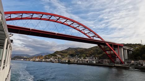 View-from-a-ferry-passing-under-the-famous-ondo-bridge-in-Kure,-Japan