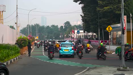 Moving-traffic-on-the-streets-of-Jakarta,-grey-and-hazy-sky-due-to-poor-air-quality-and-climate-change,-Indonesia