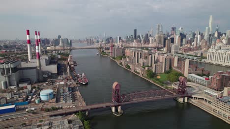 Aerial-shot-of-NYC-skyline-with-huge-factory-and-industrial-looking-bridges,-4K