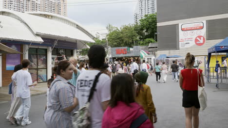 People-walk-the-vibrant-bustle-in-Bangkok's-Chatuchak-Market-with-locals-and-foreigners-shopping-in-Bangkok,-Thailand