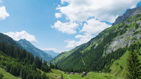 Swiss-Village-Nestled-In-Alpine-Landscape-Of-Switzerland-In-Summer