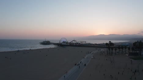 Wide-aerial-rising-shot-of-the-Santa-Monica-Pier-in-Los-Angeles,-California-at-twilight