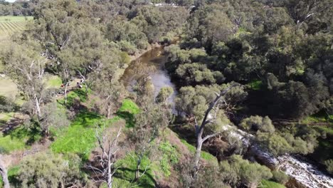 Aerial-View-Following-Powerboat-Racer-Along-The-Swan-River,-Passing-Kayaks-In-The-Avon-Descent-Boat-Race