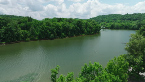 Drone-Ascending-Over-Trees-And-River-At-Mousetail-Landing-State-Park-Near-Linden-In-Perry-County,-Tennessee,-United-States