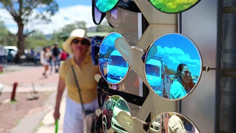 Slow-motion-shot-of-people-reflecting-in-vibrant-sunglasses-on-a-stall-in-Mexico