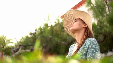 Stunning-video-of-a-caucasian-girl-wearing-a-knitted-hat-and-beautiful-green-dress-enjoying-and-admiring-the-view-of-a-beach