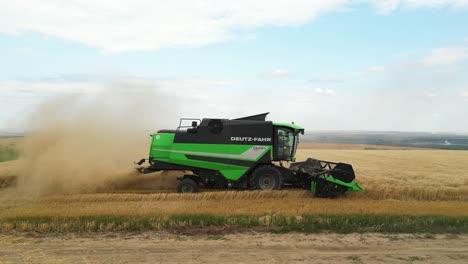 Agriculture-in-Action:-Drone-Shot-of-Green-Combine-Harvester-in-Ukrainian-Wheat-Field