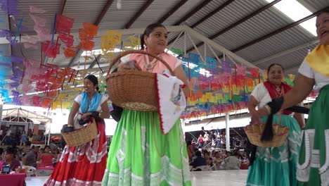 Slow-motion-shot-of-women-in-traditional-Mexican-fashion-throwing-gifts-out