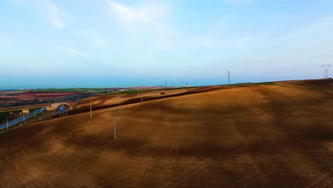 drone-aerial-shot-of-Plowed-agricultural-land-at-sunset