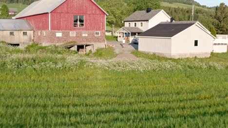 Pullback-Over-Vintage-Farmhouses-At-The-Rural-Landscape-With-Mountains-And-Spring-Field-Meadows
