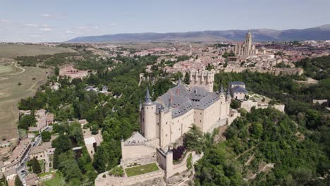 Cinematic-establishing-drone-shot-of-historic-castle,-overlooking-Segovia