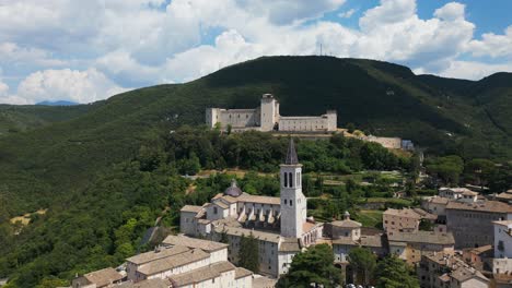 Aerial-View-Spoleto-Cathedral-Bell-Tower-With-Rocca-Albornoziana-In-Background-On-Hill-Top