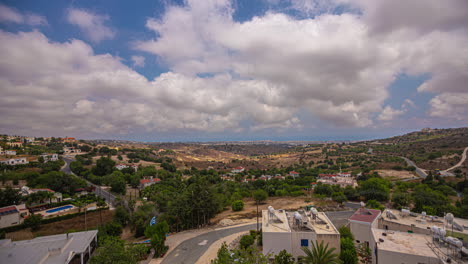 Timelapse-of-Cumulus-Clouds-Sweeping-Across-the-Blue-Skies-Over-a-Small-Town-in-Cyprus