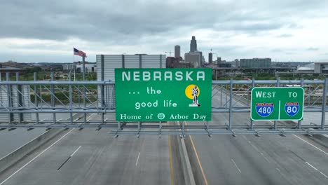 Nebraska-welcome-sign-with-Omaha,-NE-skyline-in-distance