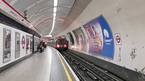 Die-Londoner-U-Bahn-Fährt-In-Den-Bahnhof-Ein,-Passagiere-Fahren-Zum-Pendeln