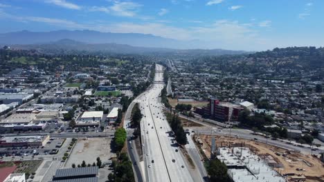 Wide-angle-aerial-view-Glendale-with-large-freeway-in-city-in-America